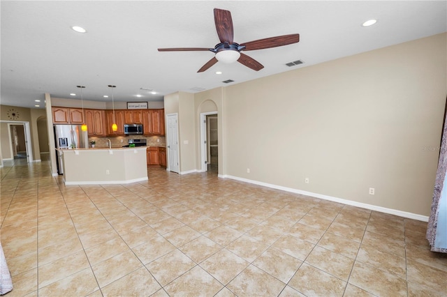 unfurnished living room featuring light tile patterned floors and ceiling fan