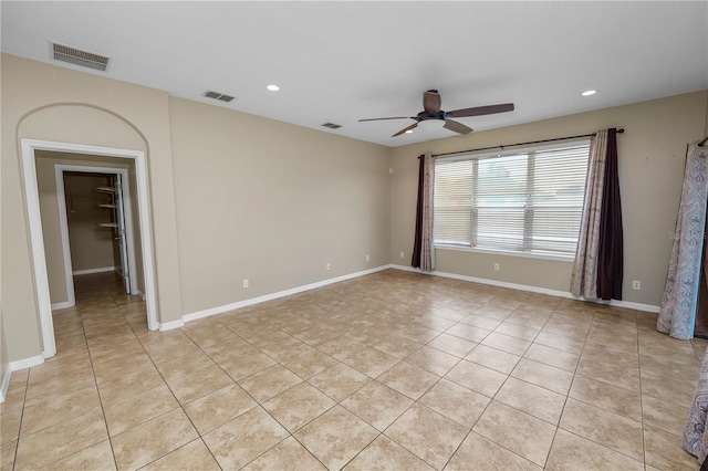 empty room with light tile patterned floors and ceiling fan