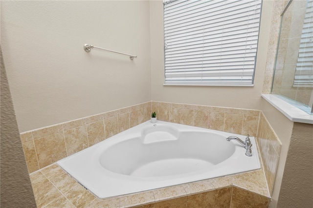 bathroom featuring a relaxing tiled tub