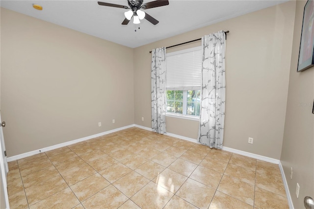 tiled spare room featuring ceiling fan