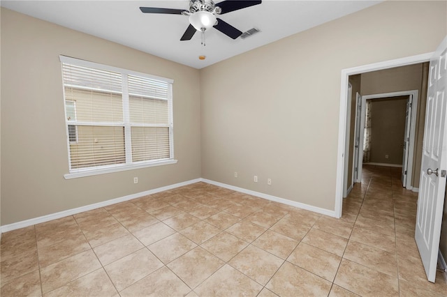 tiled empty room featuring ceiling fan