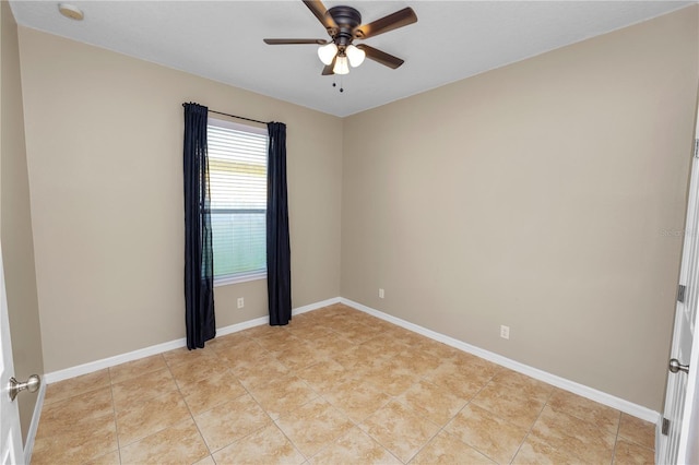 spare room with light tile patterned floors and ceiling fan