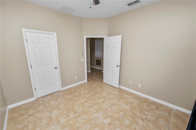 unfurnished bedroom with ceiling fan and light tile patterned floors