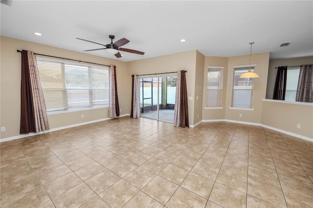 unfurnished room with ceiling fan and light tile patterned floors