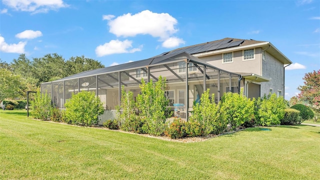 exterior space featuring a yard and glass enclosure