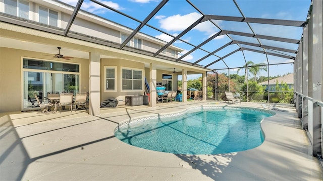 view of pool with ceiling fan, a lanai, and a patio