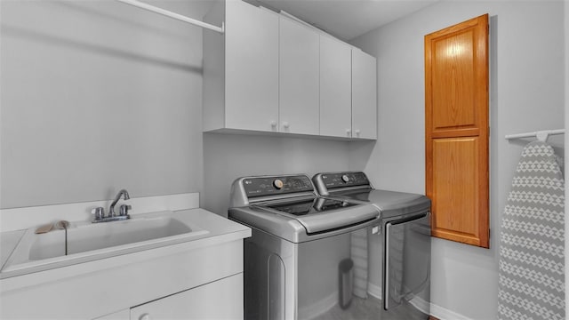 laundry room featuring sink, cabinets, and washing machine and clothes dryer