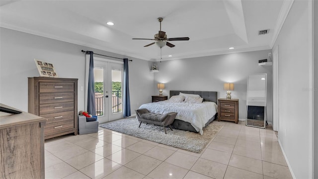 tiled bedroom featuring ornamental molding, access to exterior, ceiling fan, a tray ceiling, and french doors