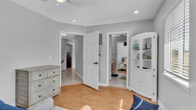 bedroom with ceiling fan and light hardwood / wood-style floors