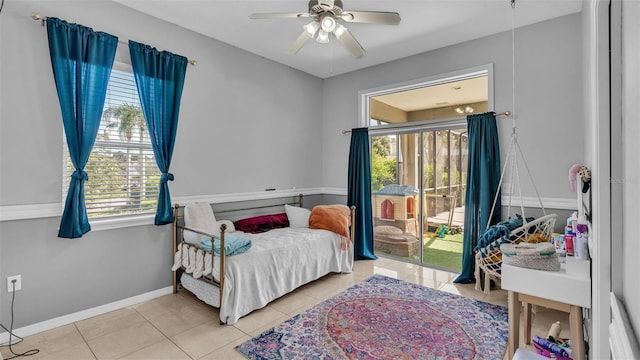 tiled bedroom with access to exterior and ceiling fan