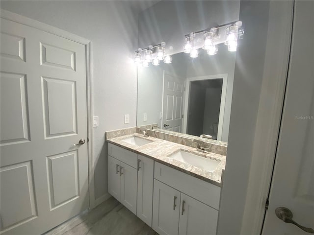 bathroom featuring double vanity, toilet, and a sink