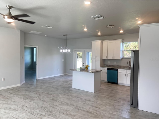 kitchen featuring white cabinetry, dishwashing machine, visible vents, and a kitchen island