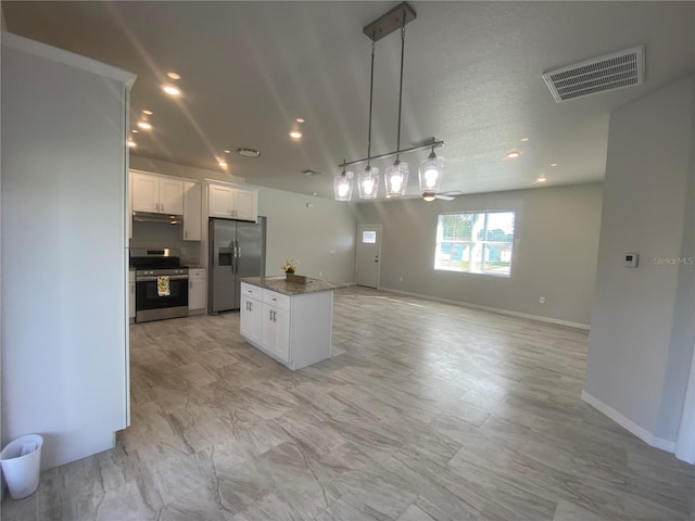 kitchen featuring stainless steel appliances, a center island, pendant lighting, white cabinets, and ceiling fan