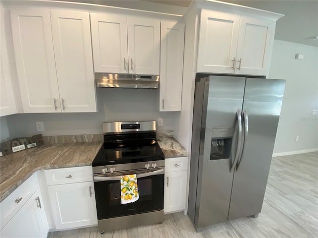 kitchen with white cabinetry, stainless steel appliances, stone countertops, and light wood-type flooring