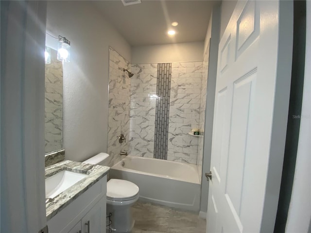 full bathroom with vanity, tiled shower / bath combo, and toilet