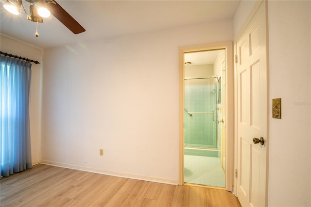 unfurnished bedroom featuring connected bathroom, light hardwood / wood-style floors, and ceiling fan