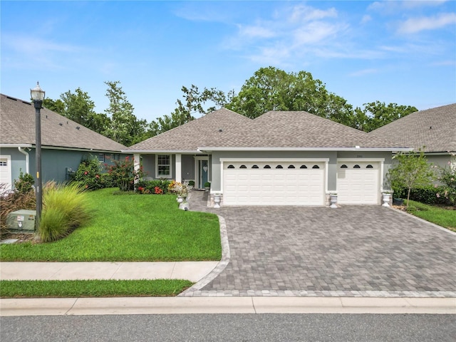 ranch-style house featuring a front lawn and a garage