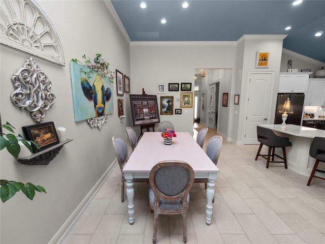 dining space with ornamental molding and vaulted ceiling