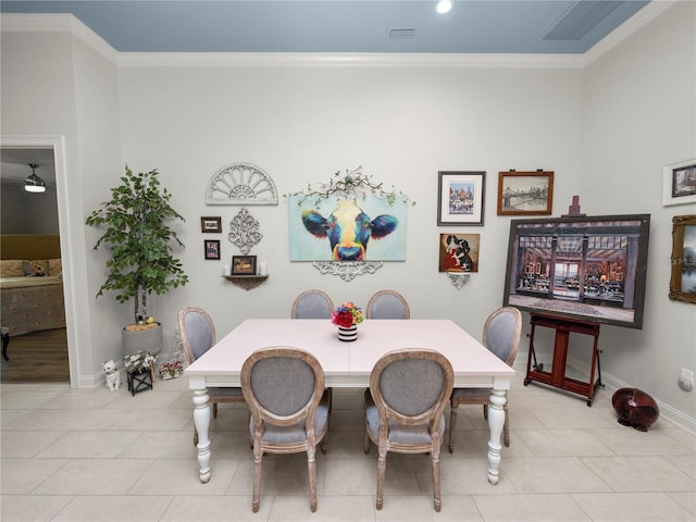 tiled dining room with crown molding