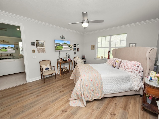 bedroom with ceiling fan, crown molding, and light hardwood / wood-style floors