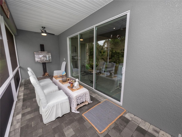 sunroom / solarium featuring ceiling fan