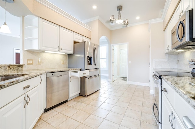 kitchen featuring crown molding, stainless steel appliances, hanging light fixtures, and white cabinets