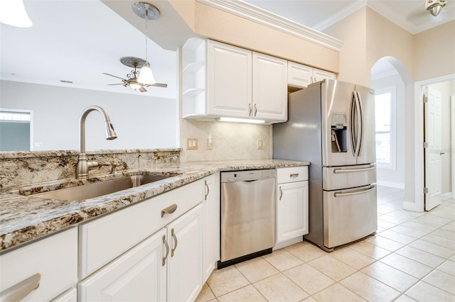 kitchen with tasteful backsplash, white cabinetry, sink, ornamental molding, and stainless steel appliances