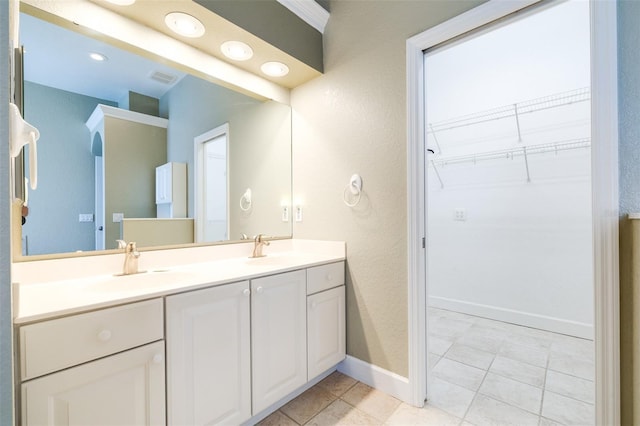 bathroom featuring tile patterned flooring and vanity