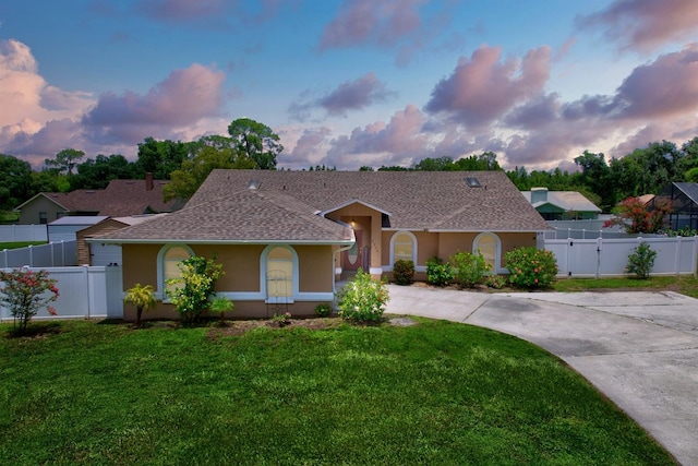 ranch-style home with a lawn