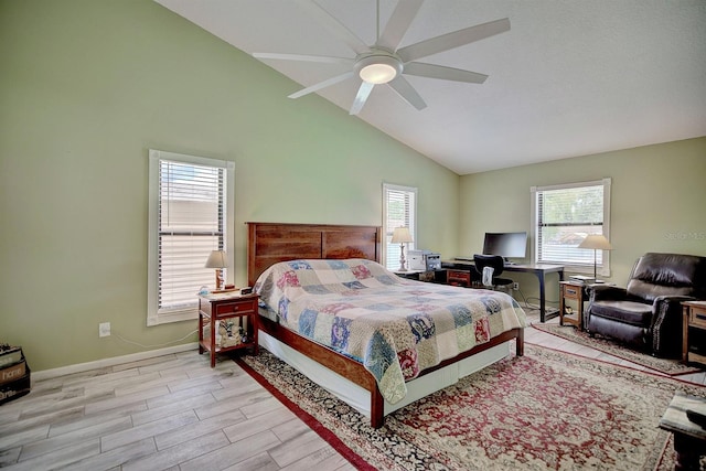 bedroom with light hardwood / wood-style floors, ceiling fan, and high vaulted ceiling