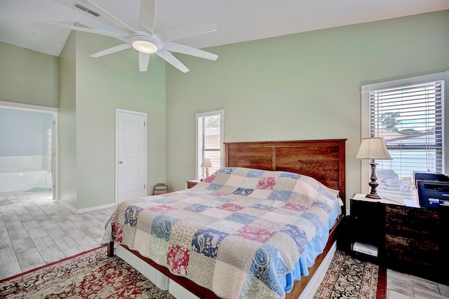 bedroom featuring hardwood / wood-style flooring, multiple windows, ceiling fan, and high vaulted ceiling