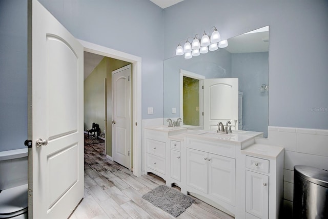 bathroom featuring double sink vanity and hardwood / wood-style floors