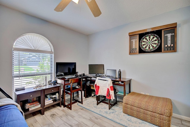 office space with light hardwood / wood-style floors and ceiling fan