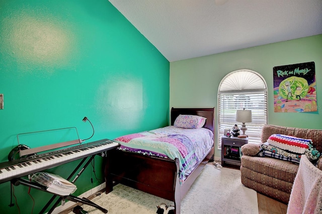 bedroom featuring lofted ceiling and light colored carpet