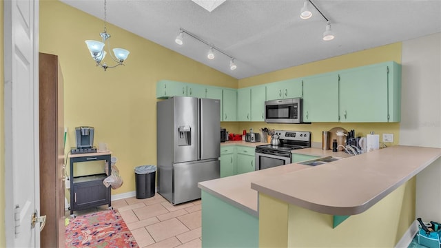 kitchen with kitchen peninsula, sink, decorative light fixtures, and stainless steel appliances