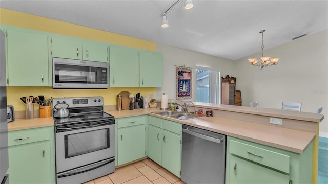 kitchen with sink, kitchen peninsula, green cabinetry, and appliances with stainless steel finishes