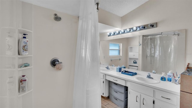 bathroom featuring curtained shower, a textured ceiling, tile patterned flooring, and vanity