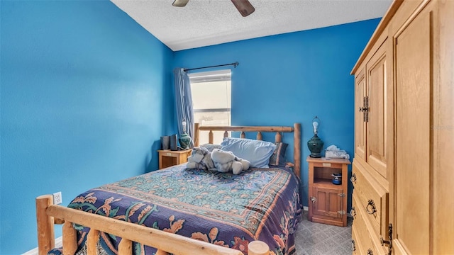 bedroom featuring ceiling fan, carpet flooring, and a textured ceiling