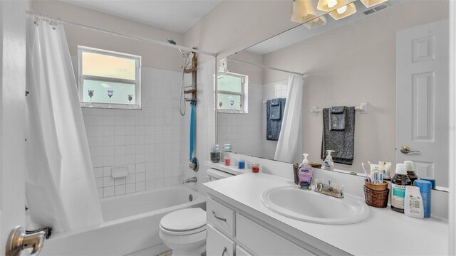 full bathroom featuring vanity, toilet, and shower / tub combo with curtain