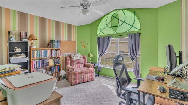 office space with ceiling fan, a textured ceiling, and light carpet