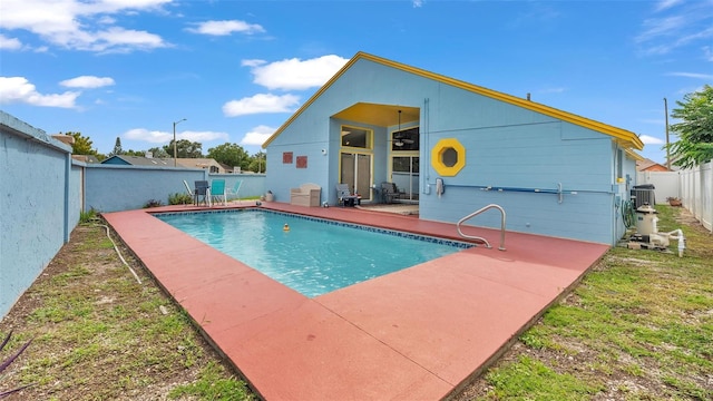 view of pool featuring a patio and central air condition unit