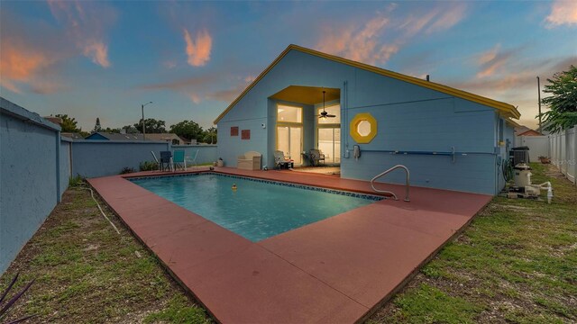 pool at dusk featuring a patio area