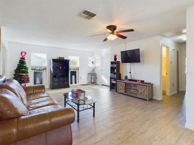 living room featuring ceiling fan and light hardwood / wood-style floors