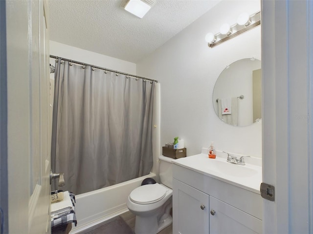 full bathroom featuring vanity, shower / tub combo with curtain, a textured ceiling, and toilet