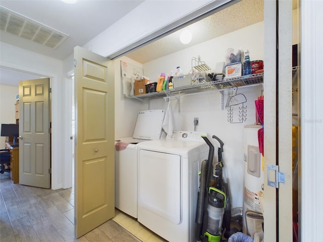 washroom featuring washing machine and clothes dryer and water heater