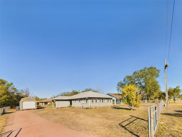 single story home featuring an outbuilding, a garage, and a front yard