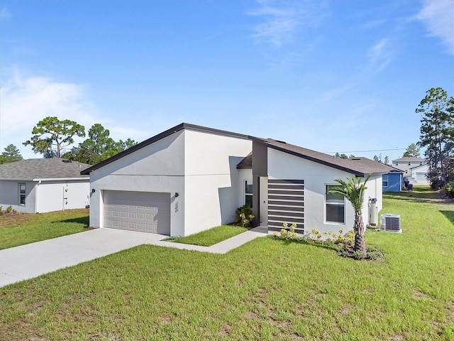 view of front of home featuring central AC unit, a garage, and a front lawn