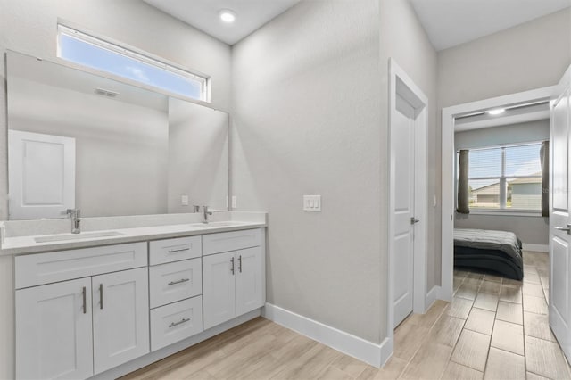 bathroom featuring hardwood / wood-style flooring, vanity, and plenty of natural light