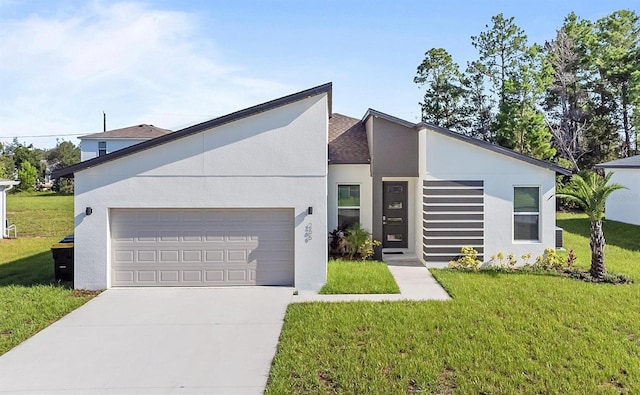 contemporary house featuring a garage and a front yard