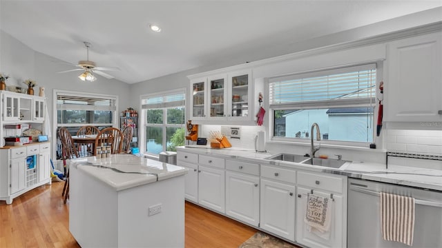 kitchen with sink, light hardwood / wood-style flooring, lofted ceiling, and tasteful backsplash